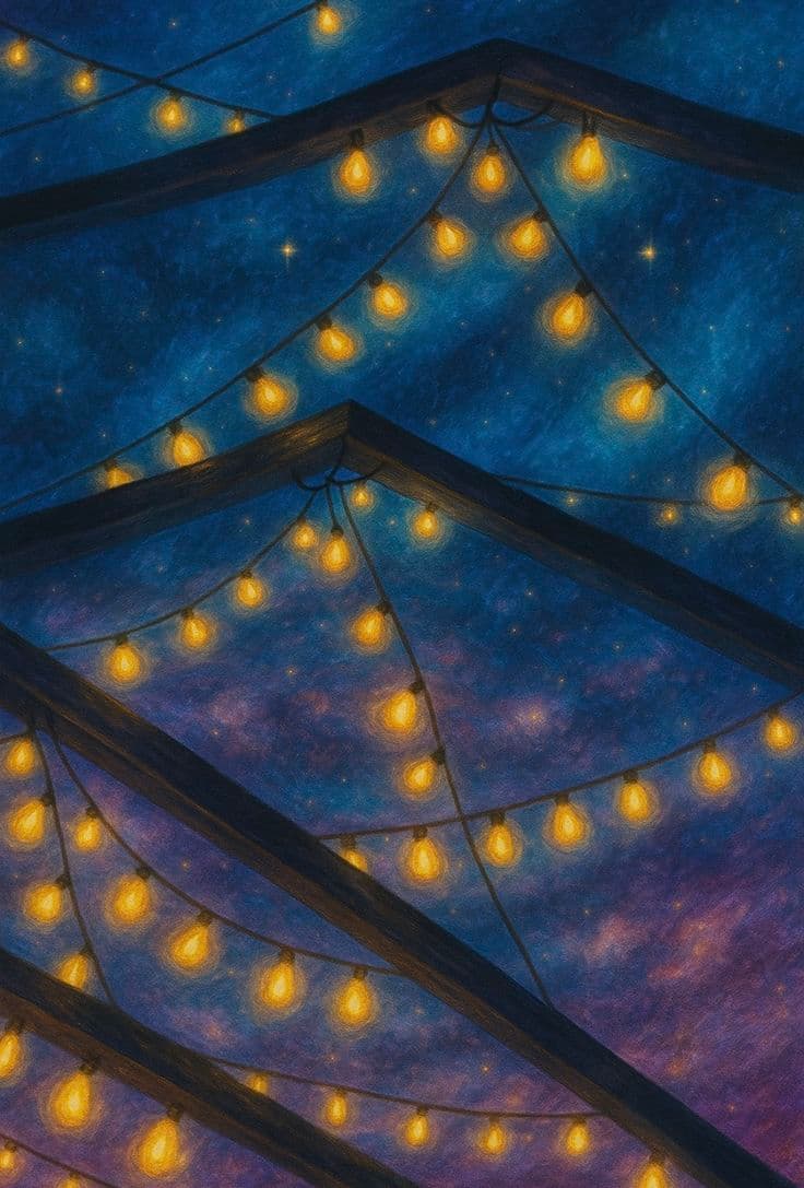 Strings of warm bulbs hung against a night sky